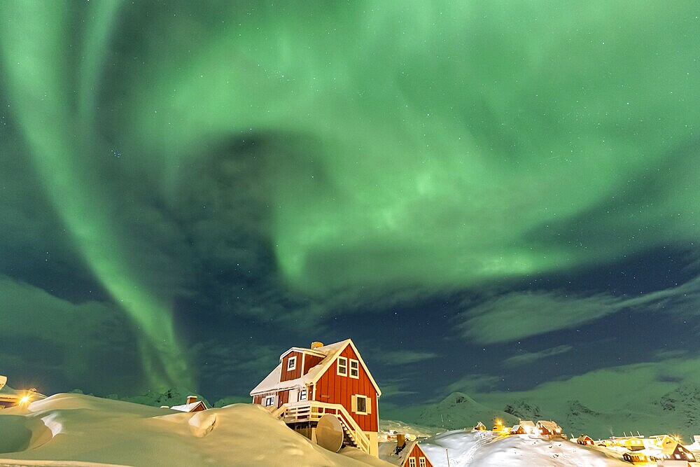 Northern Lights, Aurora borealis over red house, Inuit settlement, Winter, Tasiilaq, East Greenland, Greenland, North America