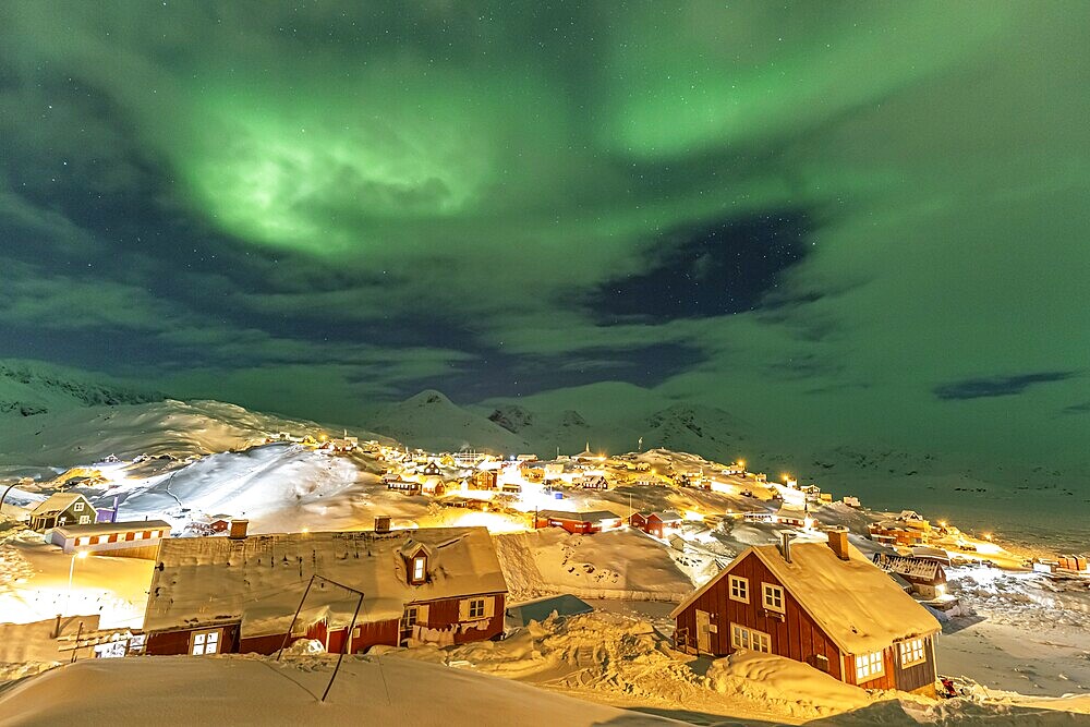 Northern Lights, Aurora borealis over houses, Inuit settlement, Winter, Tasiilaq, East Greenland, Greenland, North America