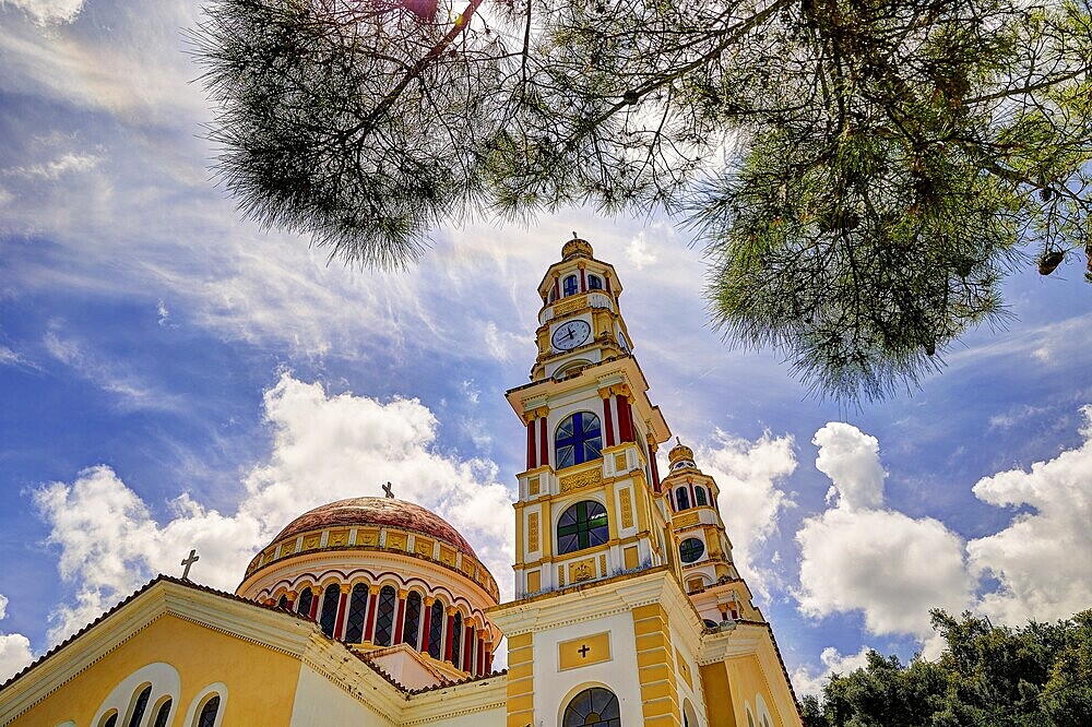 Imposing church with two towers under a bright blue sky with clouds and surrounded by trees, Church of Our Lady, Meskla, Lefka Ori, White Mountains, Mountain Massif, West, Crete, Greece, Europe