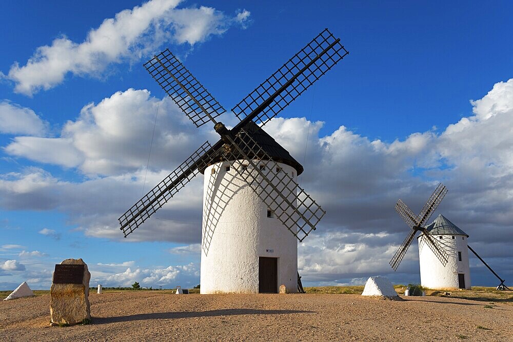 Windmill in a rural setting under a blue sky with dramatic clouds, windmills, Campo de Criptana, Ciudad Real province, Castilla-La Mancha, Don Quixote Route, Spain, Europe