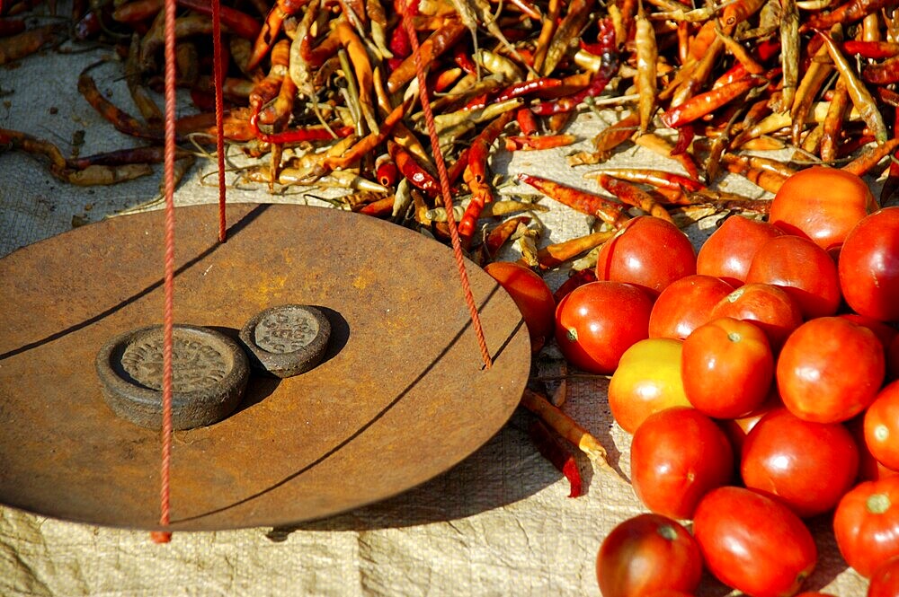 Balance with wights tikkel in chilis and tomatos on the market Khaung Daing Shan State Burma