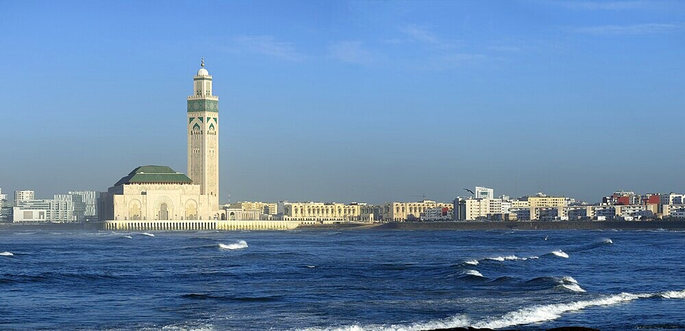 Hassan II mosque in Casablanca and Atlantic ocean waves at sunset, Morocco, panorama, Africa