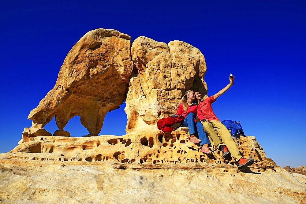 Hikers climb Elephant Rock outside of Petra, Wadi Musa, Jordan, Asia