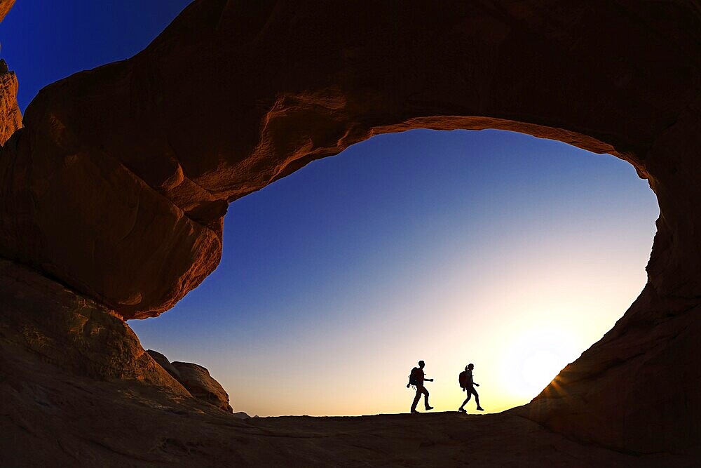 Couple hiking at Rock-Arch Al Kharza, Wadi Rum, Jordan, Asia