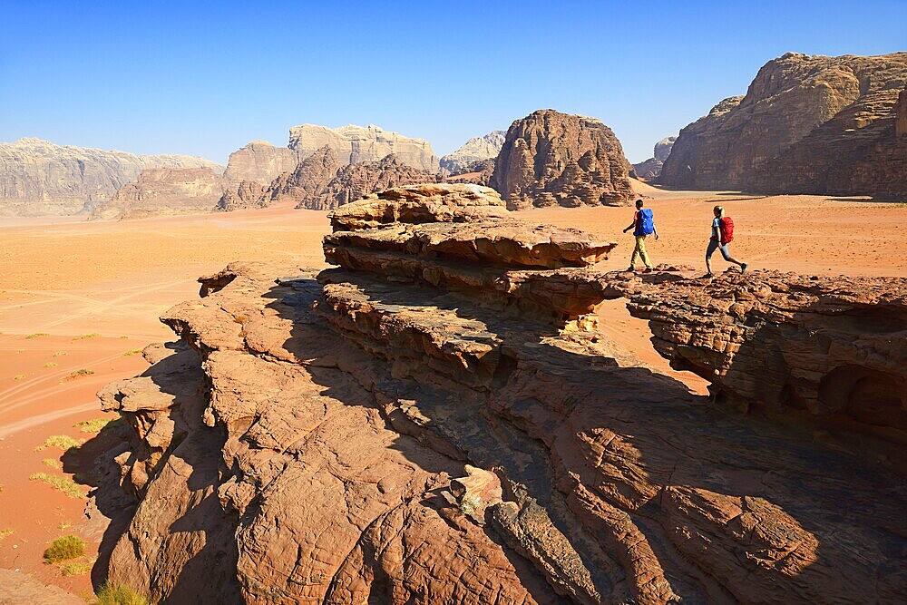 Couple hiking at Rock Arch, Al Borg Alsagheer, Wadi Rum, Jordan, Asia