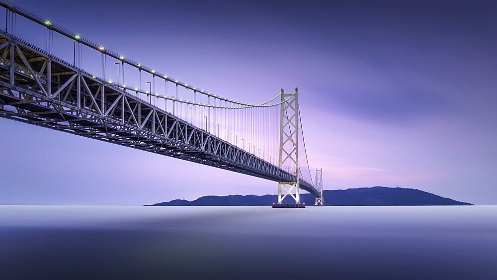 Long exposure of a colourful dusk at the illuminated Akashi Kaikyo Bridge, the longest suspension bridge in the world, in Kobe, Japan, Asia