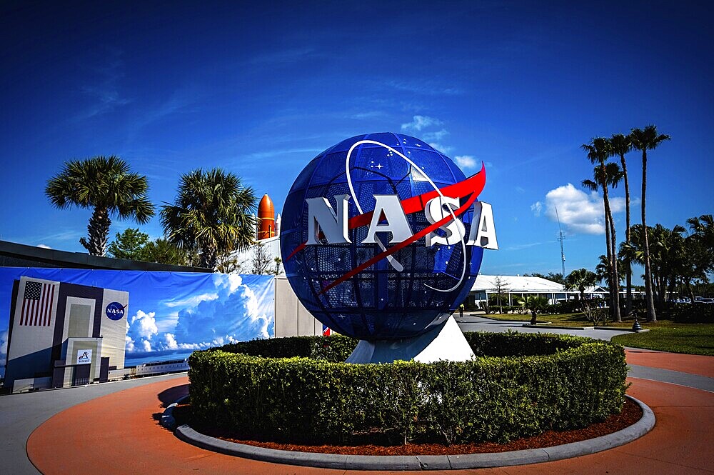 NASA logo with globe in front of blue sky and palm trees at the Kennedy Space Center, Cape Canaveral