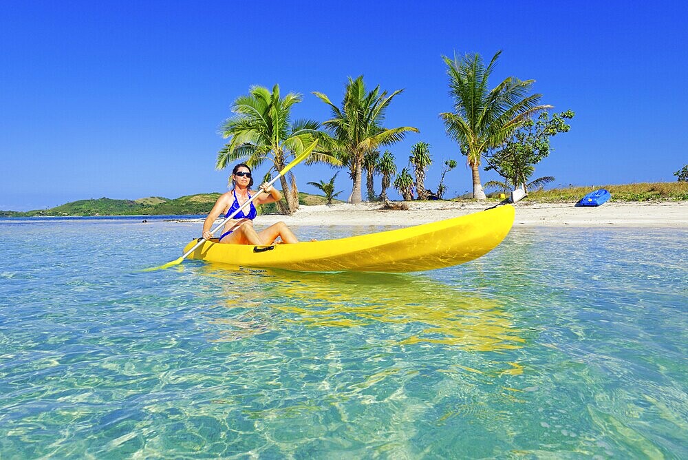Woman in yellow kayak, Yasawa, Fiji Island
