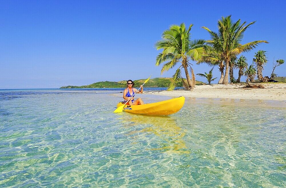 Woman in yellow kayak, Yasawa, Fiji Island