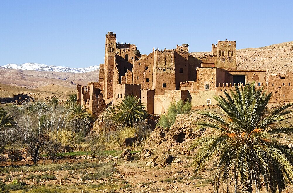 View of Tamdaght Kasbah near to Aït Benhaddou, the High Atlas mountains in the back, Southern Morocco