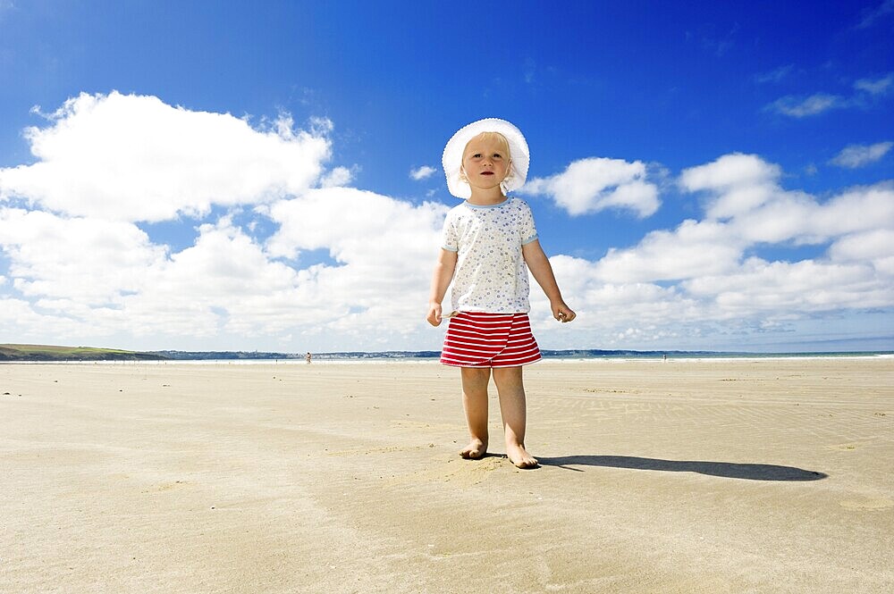Little girl walking along a beach, Brittany, France, Europe