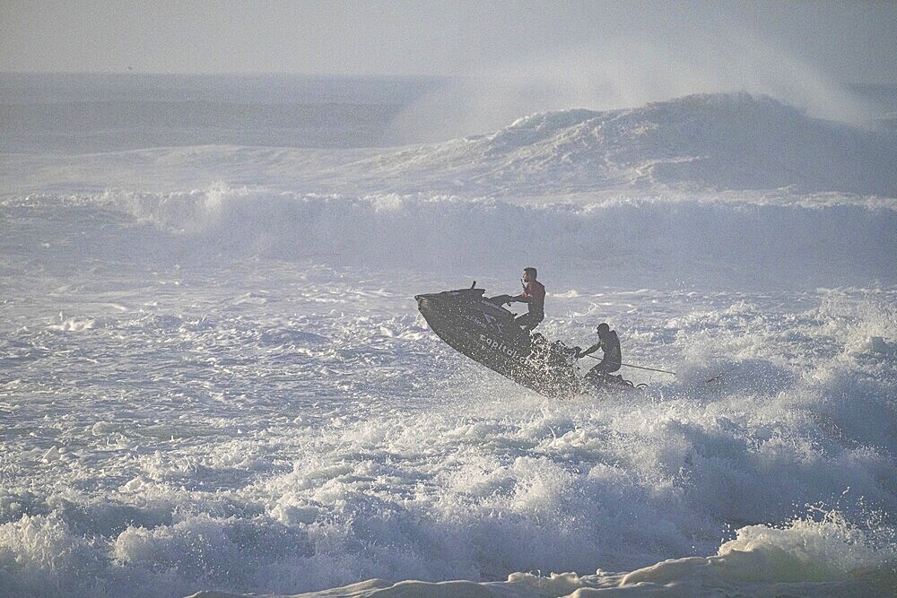 Jet ski jumping over a wave in the stormy Atlantic Ocean, Nazaré, Portugal, Europe