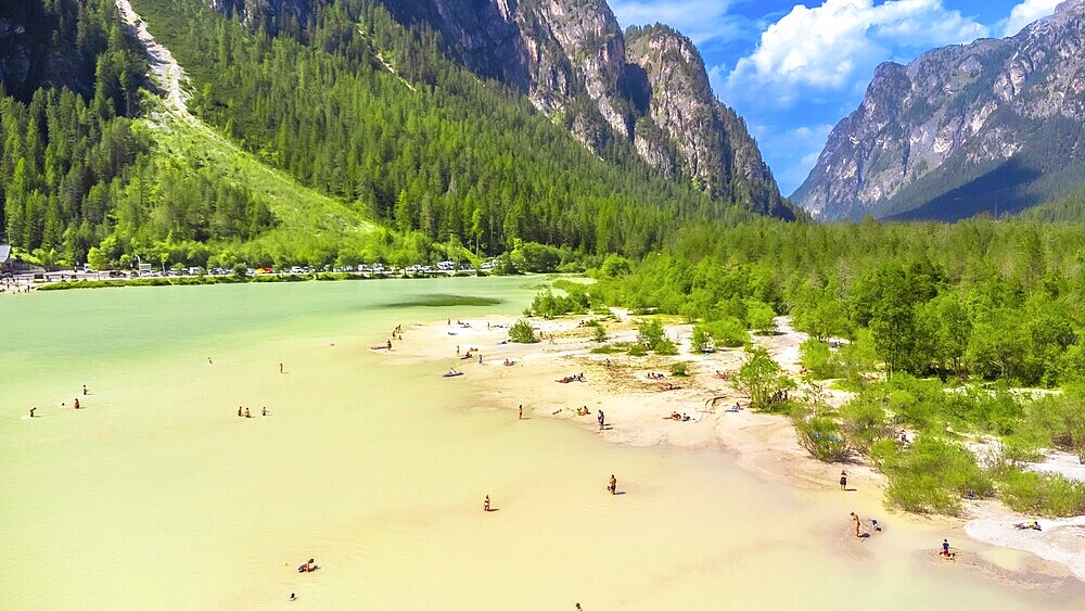 Tourists enjoying summer at lago di landro, also known as durrensee lake, surrounded by the stunning dolomites mountain range in trentino alto adige, italy