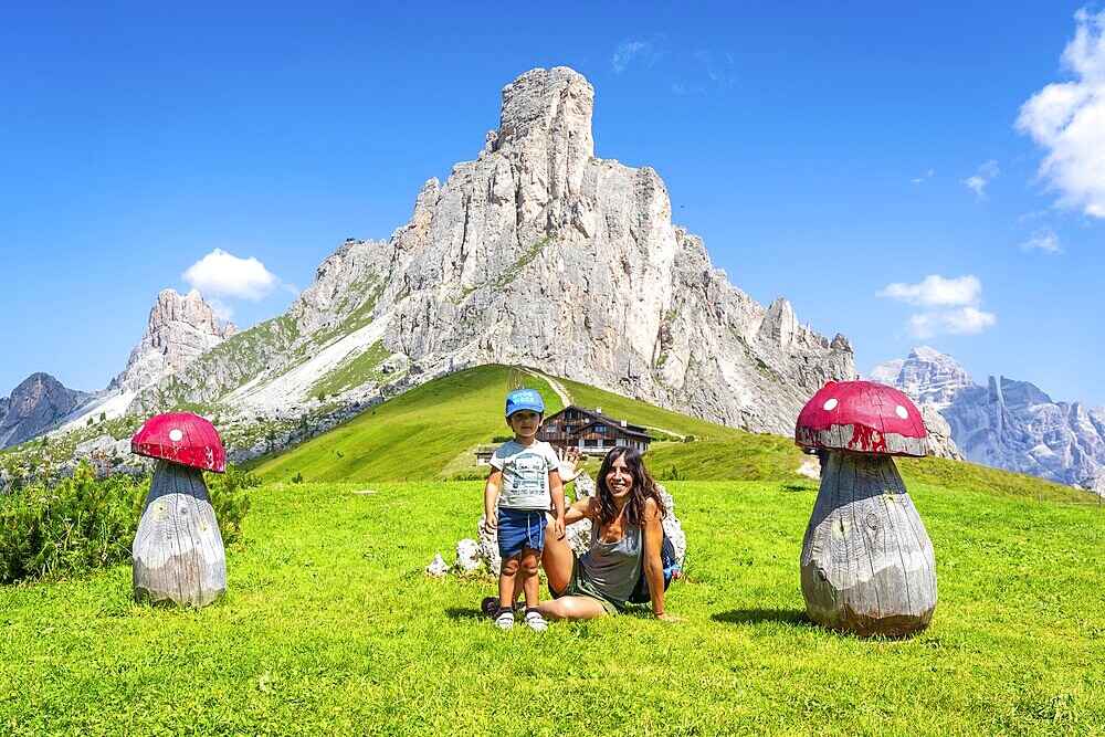 Mother and son enjoying a summer vacation in the stunning italian dolomites, surrounded by the breathtaking scenery of giau pass