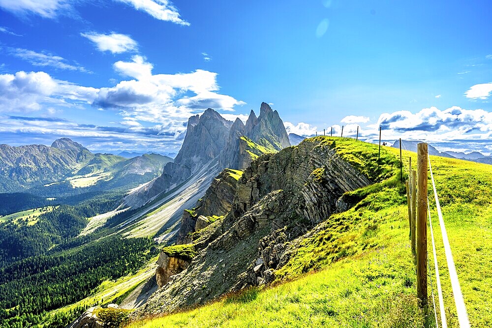 Majestic peaks of seceda rise above lush green valleys and meadows in the italian dolomites, a breathtaking summer vista