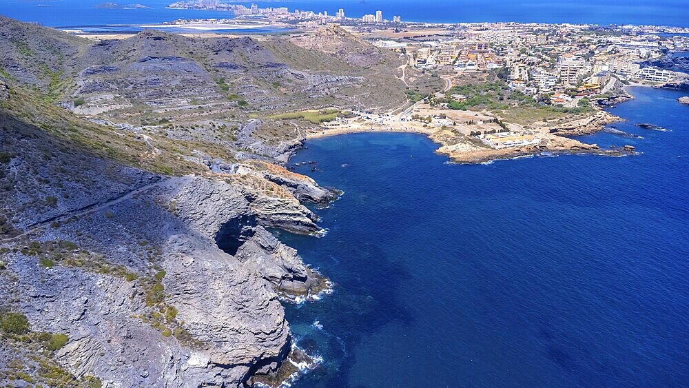 Aerial view of la manga del mar menor with its crystal clear turquoise waters gently lapping against the rocky coastline near cala reona
