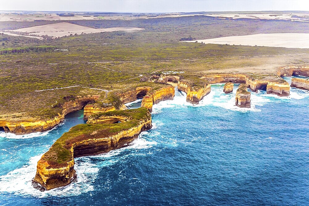 Scenic coastline. Picture taken from a helicopter. Australia, Port Campbell Park. Great Ocean Road and the Twelve Apostles is a group of limestone cliffs. The concept of extreme, active and photo tourism