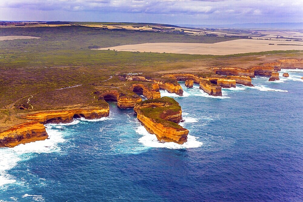 Australia. The Great Ocean Road goes along the Pacific coast. Picturesque shoreline. The picture was taken from the helicopter. The concept of extreme and active tourism