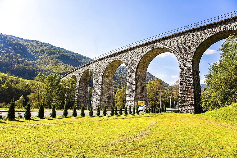 Picturesque Julian Alps. Beautiful sunny autumn day. Majestic powerful bridge over the river Idrija. The beauty of the Julian Alps. Travel to Slovenia