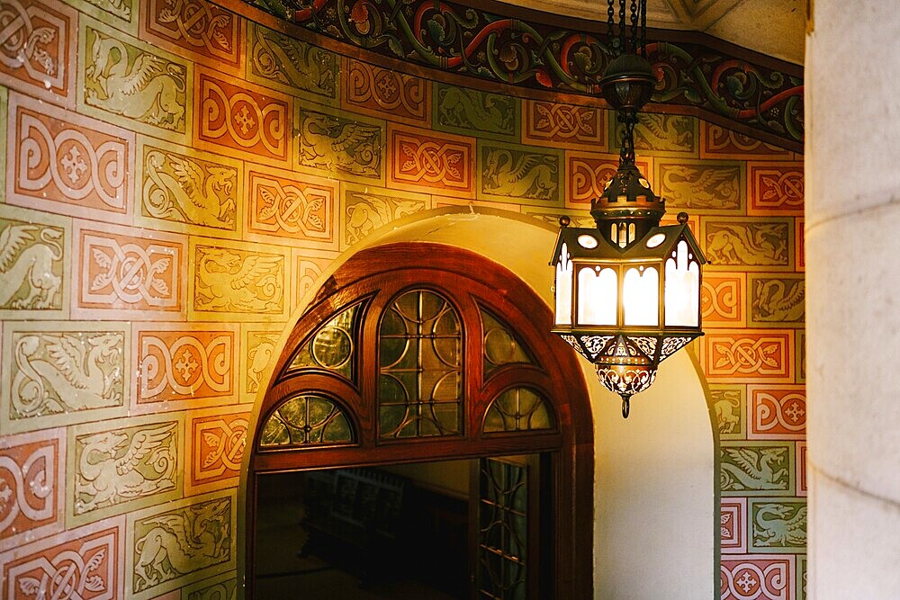 Antique wall lamp on a spiral staircase in Neuschwanstein Castle.