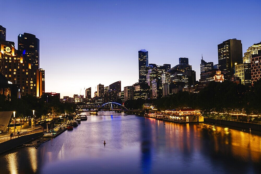 MELBOURNE, AUSTRALIA - OCTOBER 10, 2024: Melbourne skyline from Princes Bridge in Southbank along the Yarra River at dusk in Victoria, Australia, Oceania