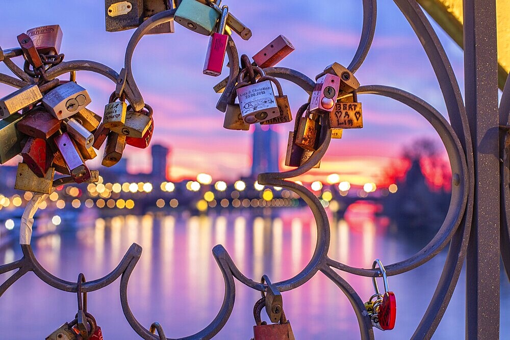 Sunrise on a riverbank in the centre of a big city. Spring with a view of the skyline of the banking district and the historic buildings of Frankfurt, Hesse