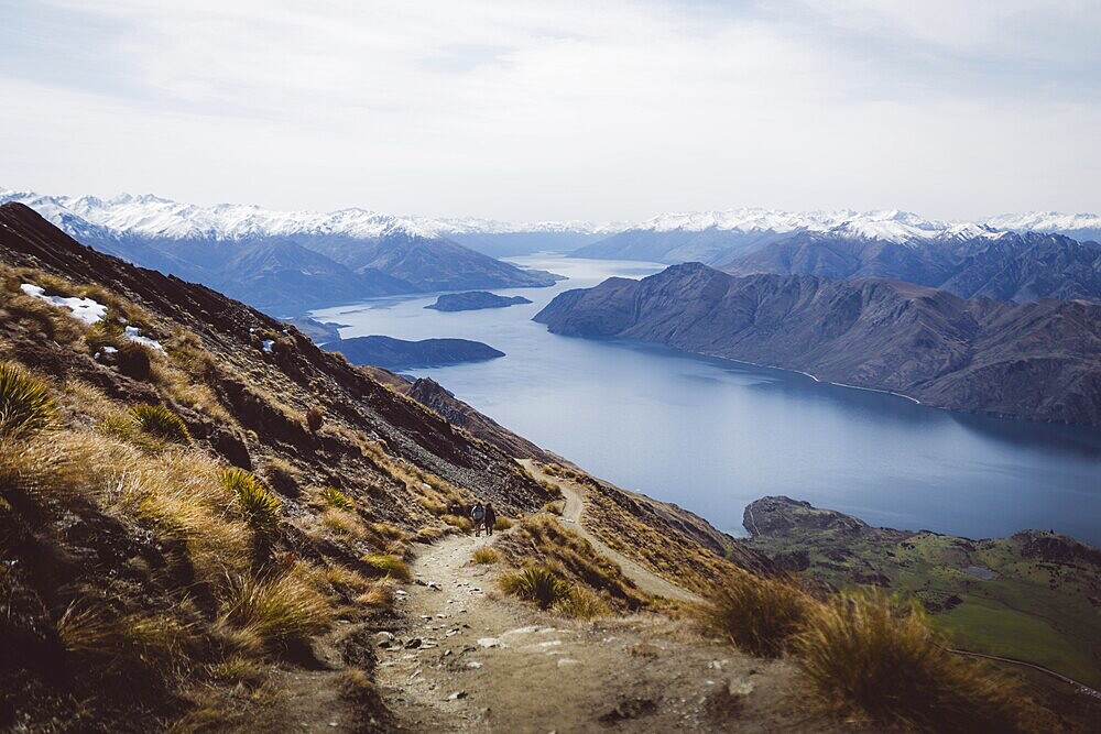 Spectacular views from a path leading through a mountainous landscape to a lake, Roys Peak, Wanaka, New Zealand, Oceania