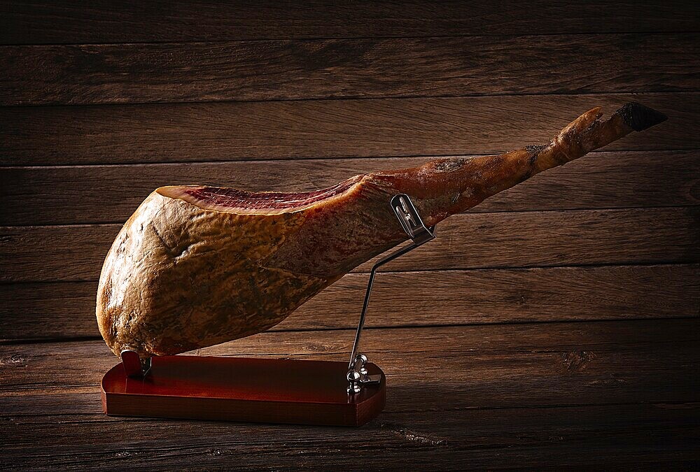 Iberian ham pata negra from Spain on wood background
