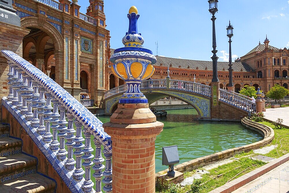 Close-up of a tiled bridge at the Plaza de España in Seville with water in the background, Seville, Spain, Europe