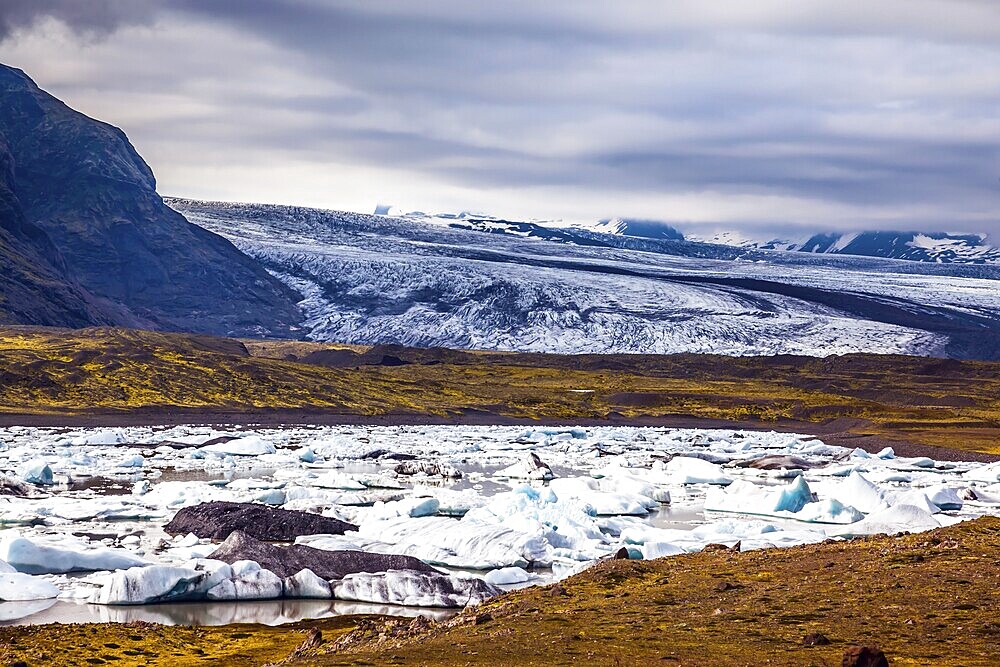 Sunrise in the Ice Lagoon. Drift ice Ice Lagoon - Jokulsarlon. Ice floes are reflected in the smooth water surface. The concept of extreme northern tourism