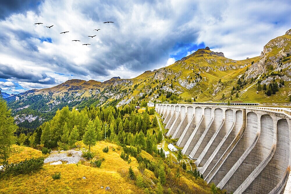 Powerful dam blocked the lake. Mountain Lake Lago di Fedaia, Dolomites. The concept of ecological and extreme tourism