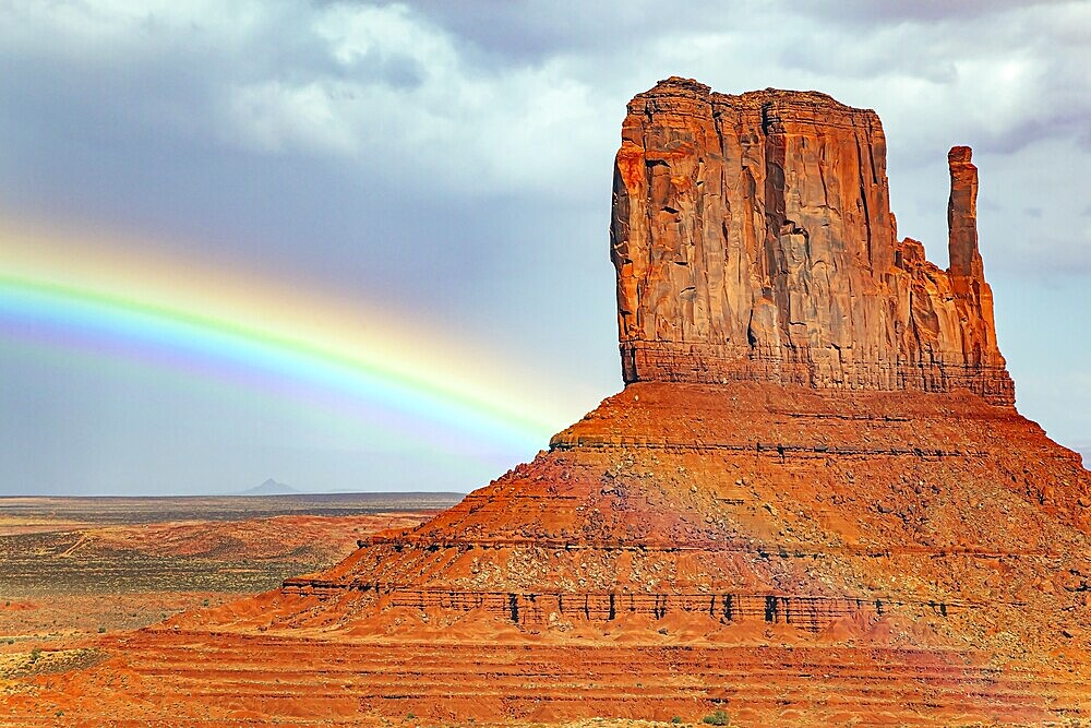 The famous rock Mittens and the bright rainbow. USA. Navajo Indian Reservations. Monument Valley is a unique geological formation in Arizona and Utah