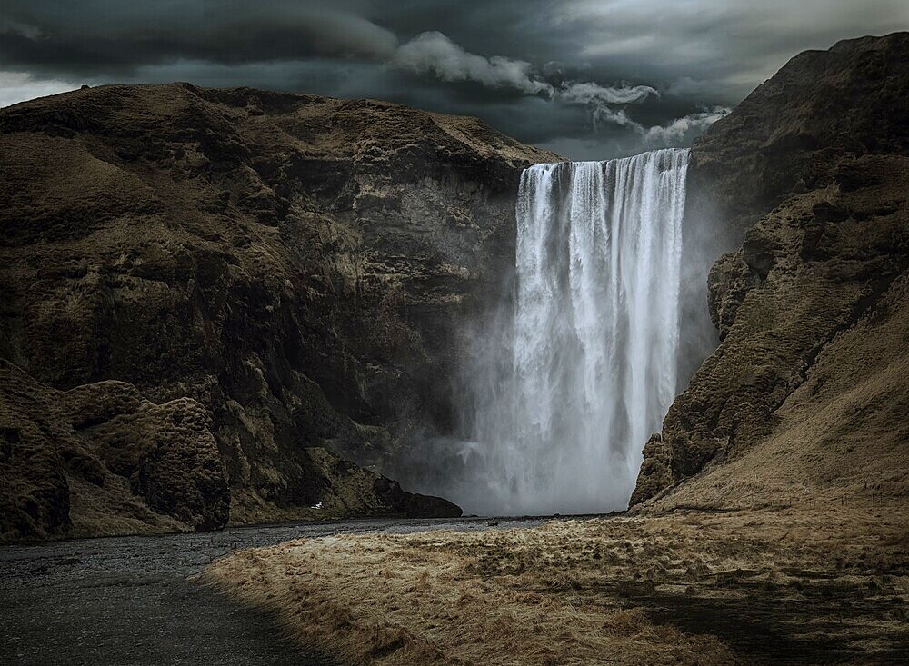 Majestic and dark Skogafoss waterfall in Iceland in a stormy day, moody atmosphere
