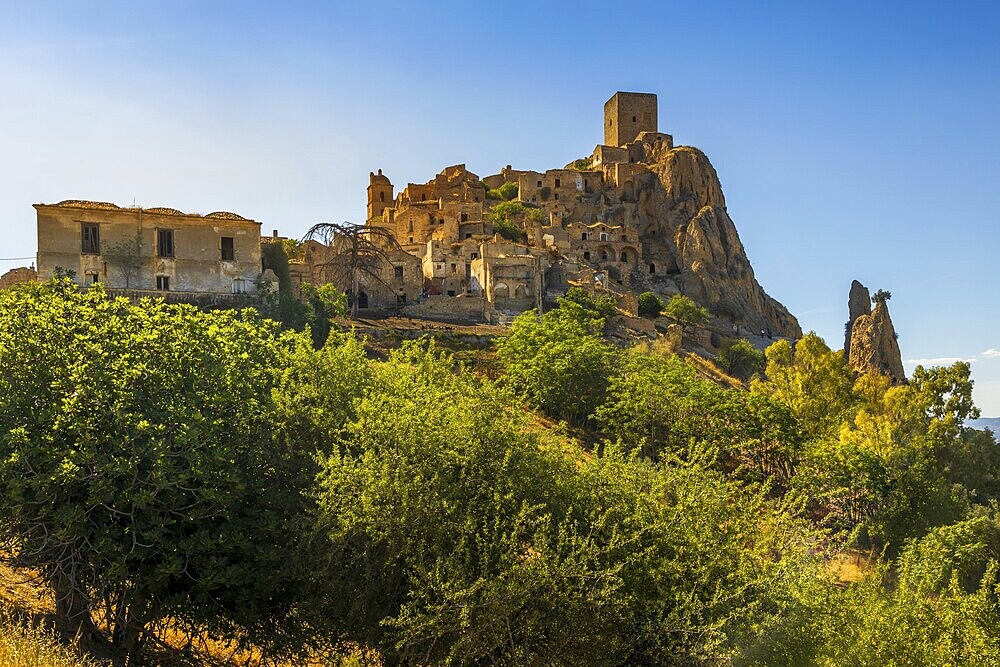 A picturesque view of the abandoned, old mountain town of Craco, built of sandstone rock. Craco is a ghost town abandoned due to an earthquake in the late 20th century. Province of Matera, Basilicata, Italy