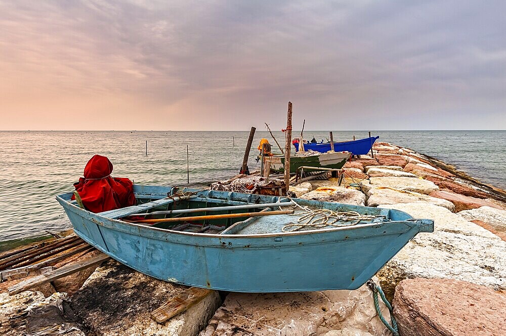 Fishing boat moored on cliff at sunset. Venice, Italy