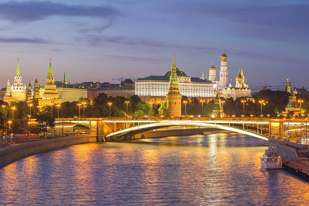Illuminated Moscow Kremlin and Moscow River with bridge at night. Russia