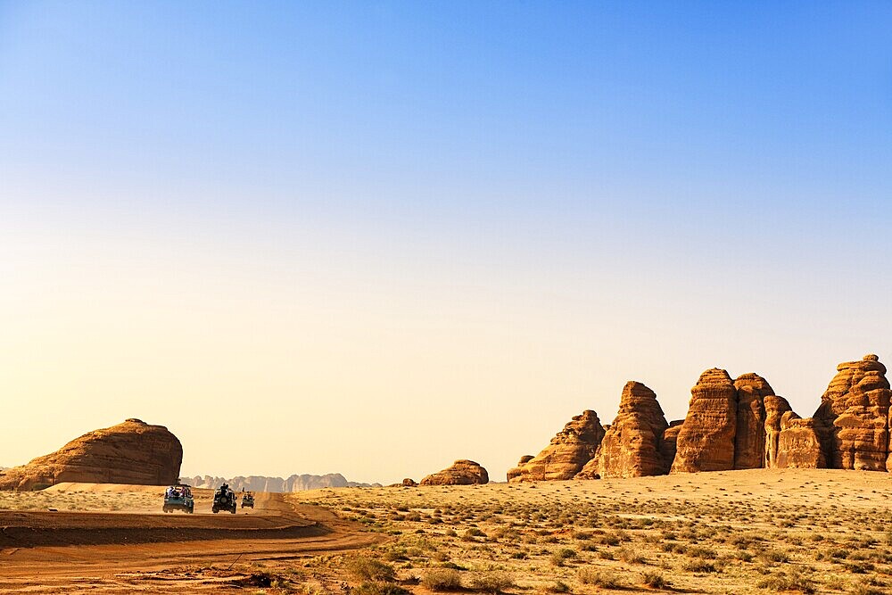 Vintage Land Rover Tour in the rocky landscape of Hegra, Unesco World Heritage Site Al Ula, Kingdom of Saudi Arabia