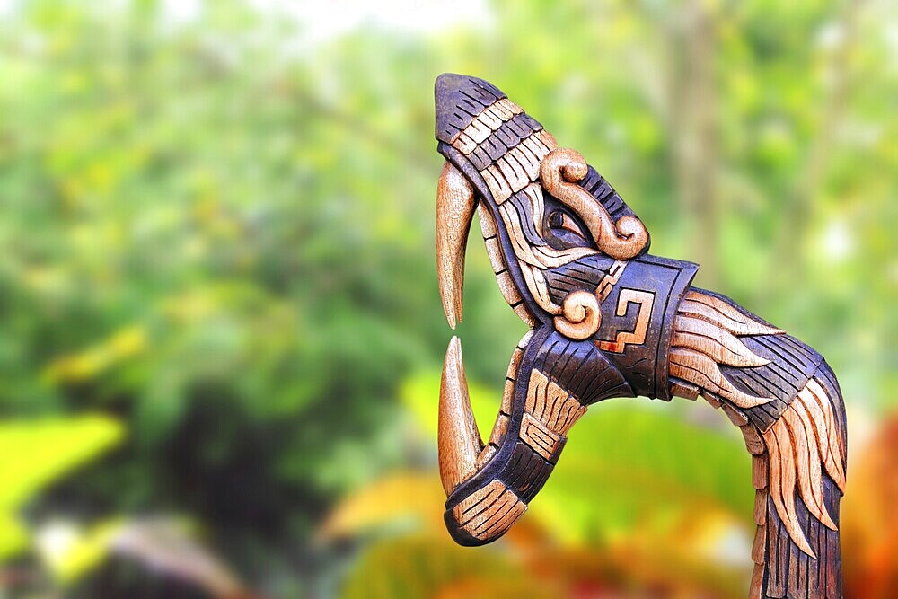Chichen Itza Snake symbol wood handcraft figure in jungle Mexico Yucatan