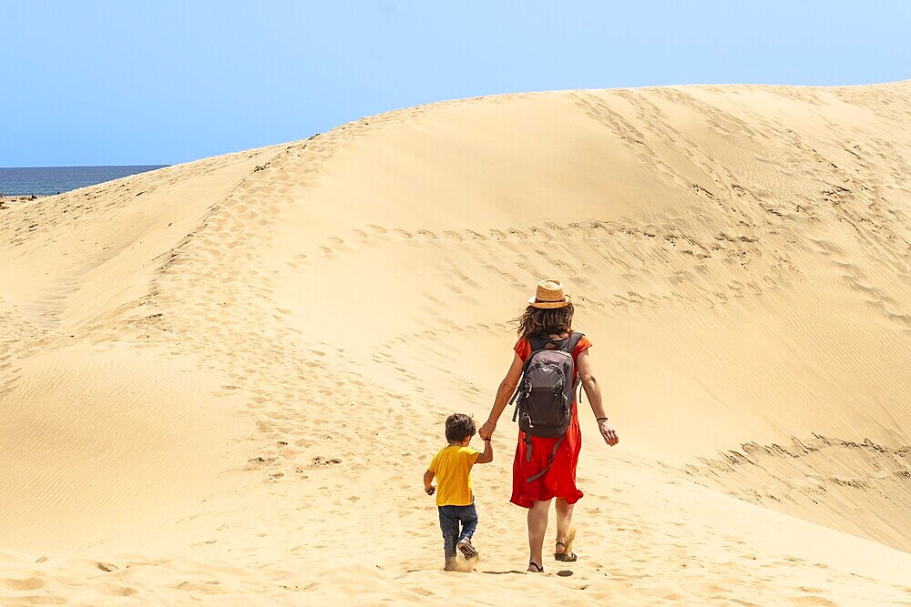 Mother and child on vacation in the dunes of Maspalomas, Gran Canaria, Canary Islands