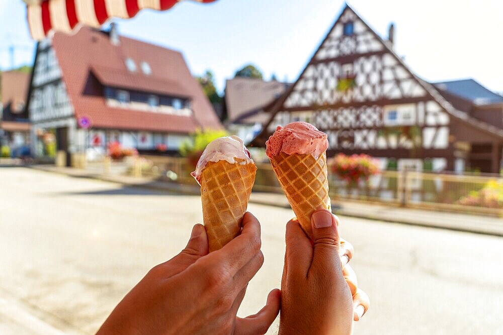 Eating ice cream in summer in the medieval mountain village of Sasbachwalden, Black Forest, Germany