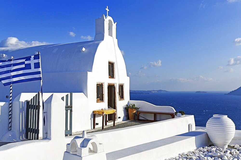 White architecture, orthodox church by the sea, Greek flag, blue sky, Oia, Santorini, Cyclades, Aegean Sea, Greece