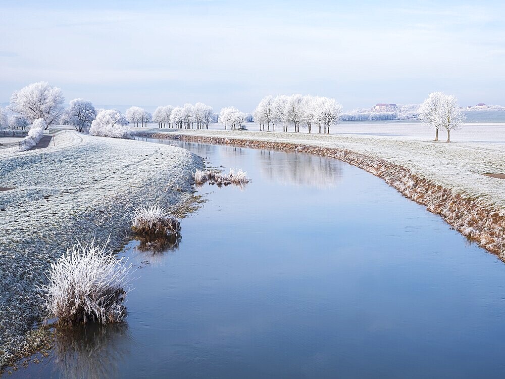 The river Unstrut in the Unstrut valley in winter, fields and trees covered with hoarfrost, behind Wendelstein Castle, Memleben, Saxony-Anhalt, Germany