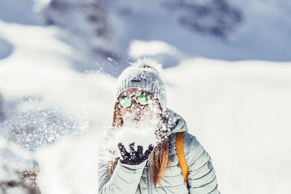 Woman in wintry surroundings in the Engadine in Switzerland