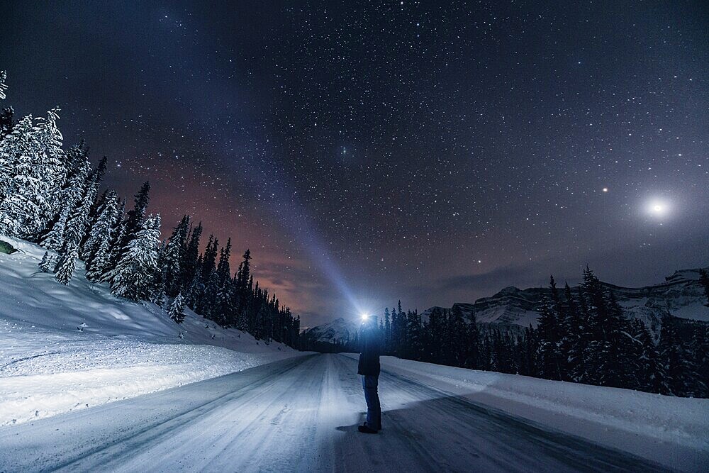 Starry sky during a winter road trip on the Icefields Parkway with lots of snow and ice, Banff National Park, Jasper National Park, Alberta, Canada