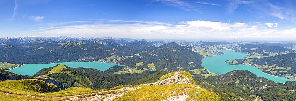 Panoramic view from the top of Mount Schafberg over the landscape with cross and mountains and Lake Mondsee and Wolfgangsee, Alps, Austria