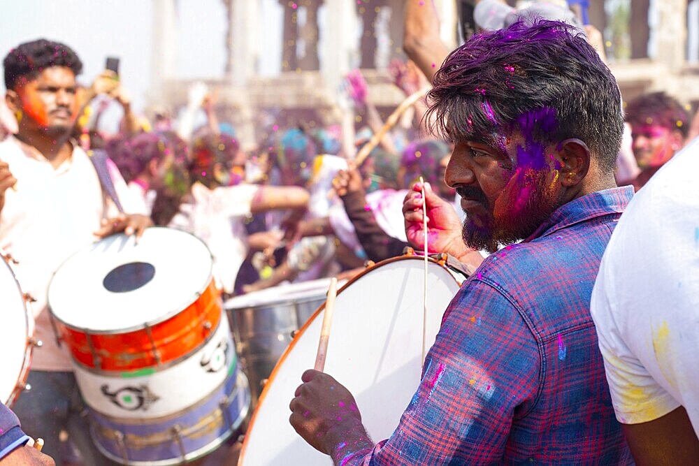 Holi festival in Hampi, India, state of Karnataka, 15.03.2025, people celebrating the hindu holiday of colours, powerful drummers playing drums