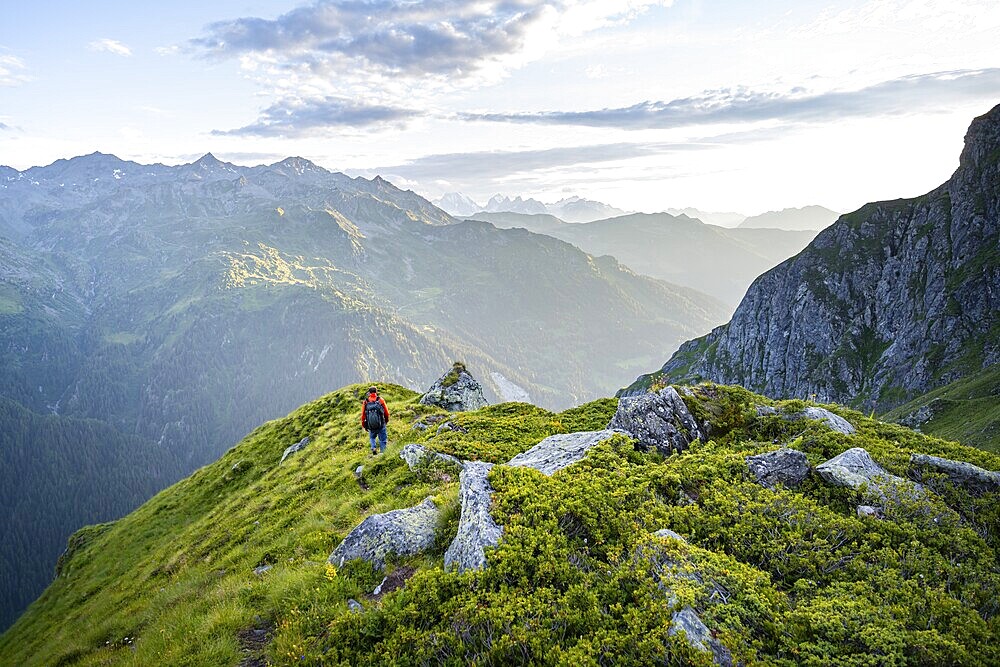 Mountaineers in a picturesque mountain landscape in the atmospheric evening light, view from the Cabane du Louvie, Valais Alps, Val de Bagnes, Valais, Switzerland