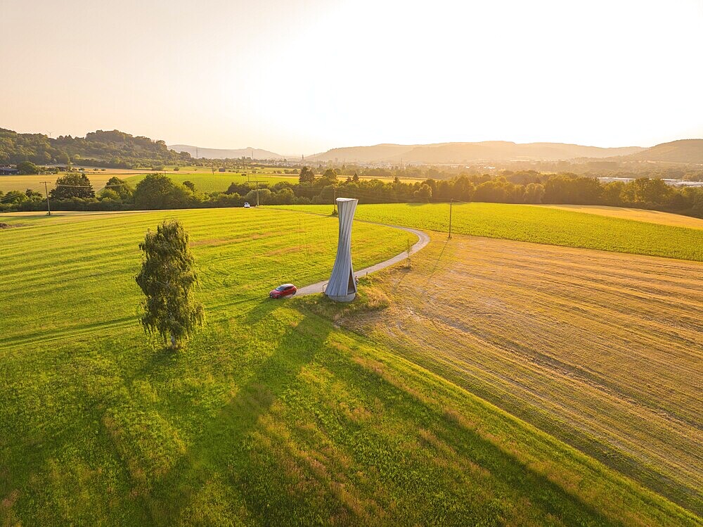 Extensive landscape with a viewing tower under a clear sky in a summery atmosphere