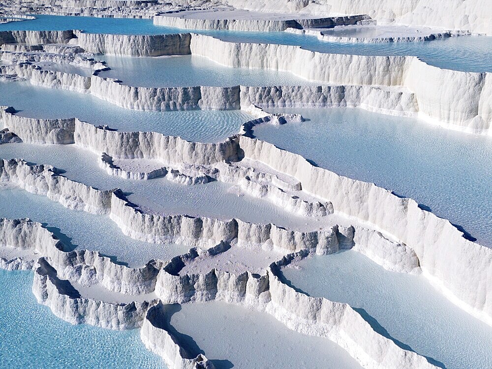 White limestone terraces with turquoise-coloured water under a clear sky, aerial view, sinter terraces, limestone sinter terraces, travertine terraces, Pamukkale, Denizli, UNESCO World Heritage Site, Anatolia, Turkey