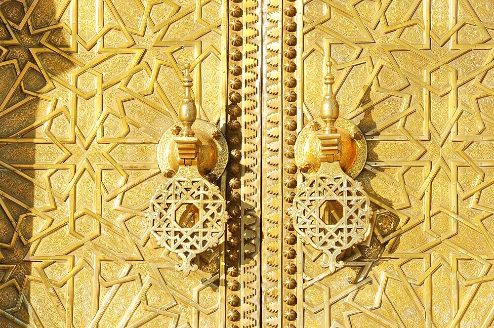 Entrance area of a royal palace, Symmetrical view of a Moroccan palace with ornate Tor tor, North Morocco, Morocco, Close-up of a richly decorated golden door with complex patterns, Fez, North Morocco, Morocco
